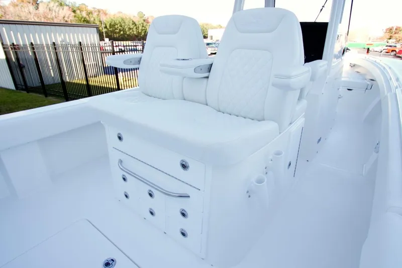 Slide: The Image of 2026 Regulator 31 boat interior with white cushioned seating and storage compartments. - 21
