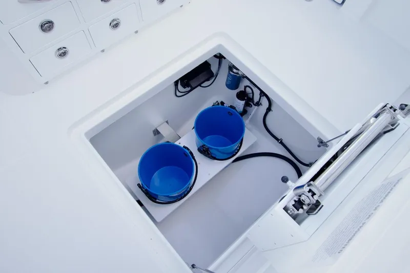 Slide: The Image of Storage compartment on 2026 Regulator 31 boat with blue buckets and equipment. - 24
