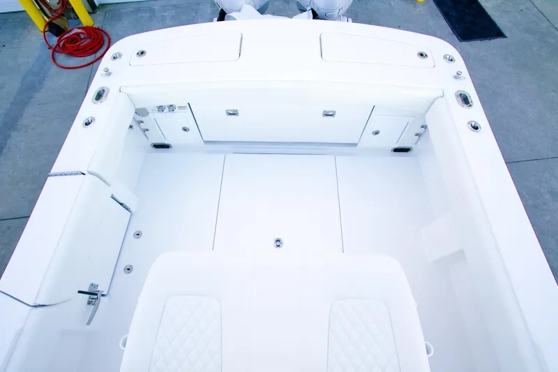 Slide: The Image of 2026 Regulator 31 boat interior with white seating and storage compartments. - 25