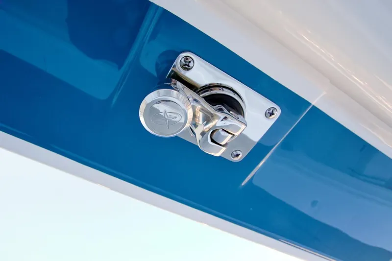 Slide: The Image of Chrome latch on 2026 Regulator 31 boat, mounted on blue surface. - 31