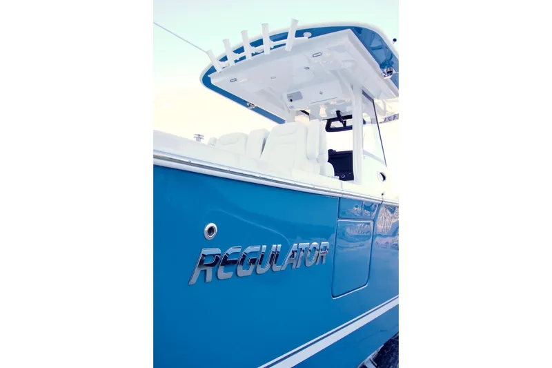 Slide: The Image of 2026 Regulator 31 boat, blue hull, sleek design, modern features, side view. - 32