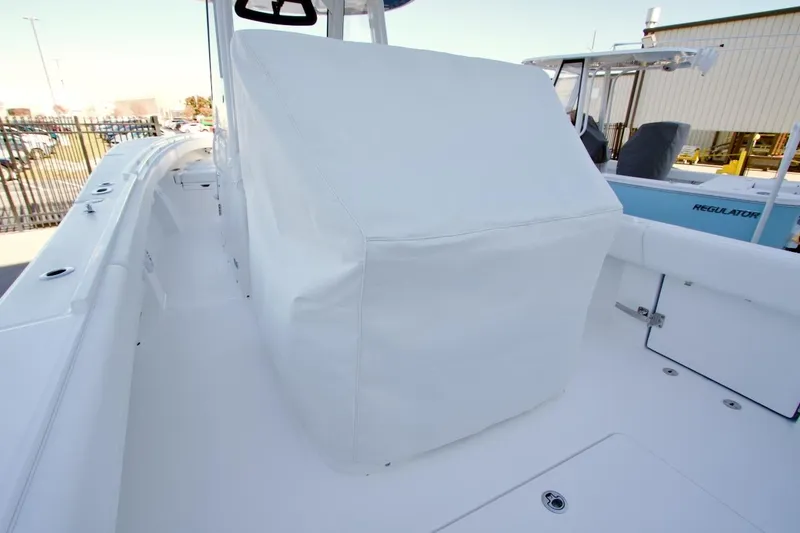 Slide: The Image of 2026 Regulator 31 boat interior with covered console, docked outdoors. - 6