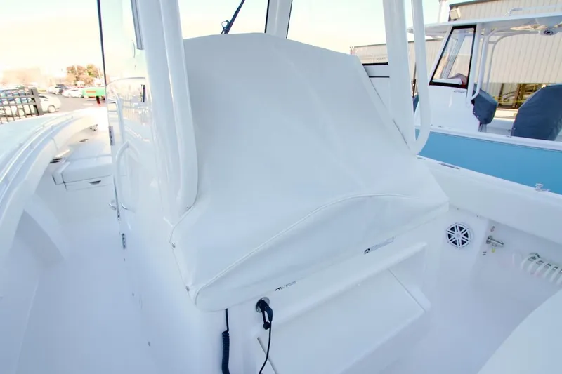 Slide: The Image of 2026 Regulator 31 boat interior with covered console and seating area. - 7