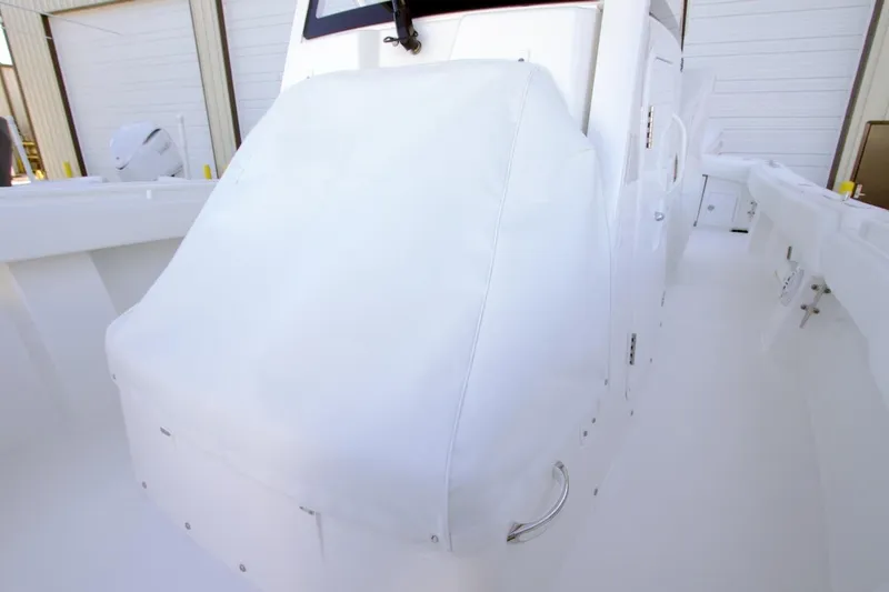 Slide: The Image of 2026 Regulator 31 boat interior with covered console in a storage facility. - 8