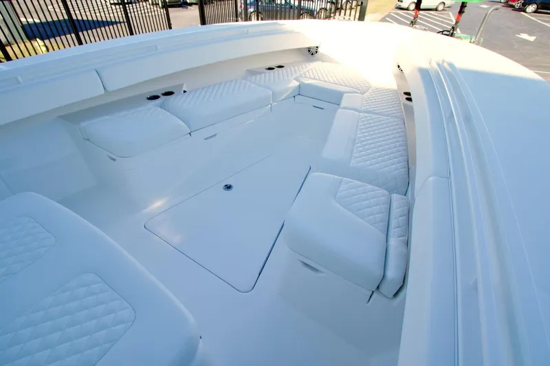 Slide: The Image of 2026 Regulator 31 boat interior with white cushioned seating and storage compartments. - 9