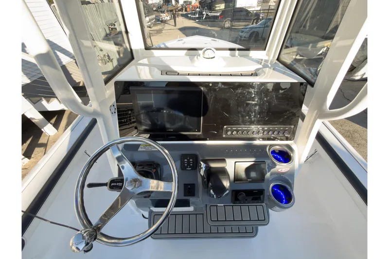 Slide: The Image of 2026 Tidewater 2300 Carolina Bay boat dashboard with steering wheel and control panel. - 11