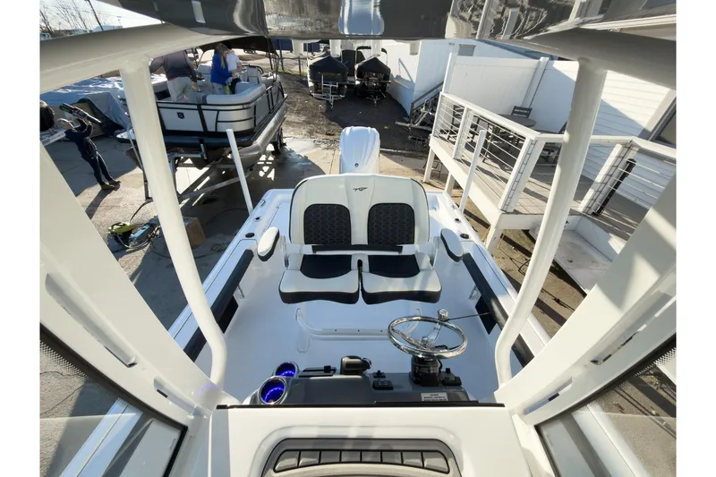 Slide: The Image of 2026 Tidewater 2300 Carolina Bay boat interior with steering wheel and seating. - 16