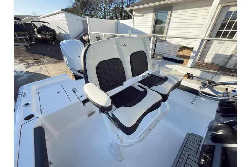 Slide: The Image of 2026 Tidewater 2300 Carolina Bay boat interior with dual seating and steering wheel. - 17