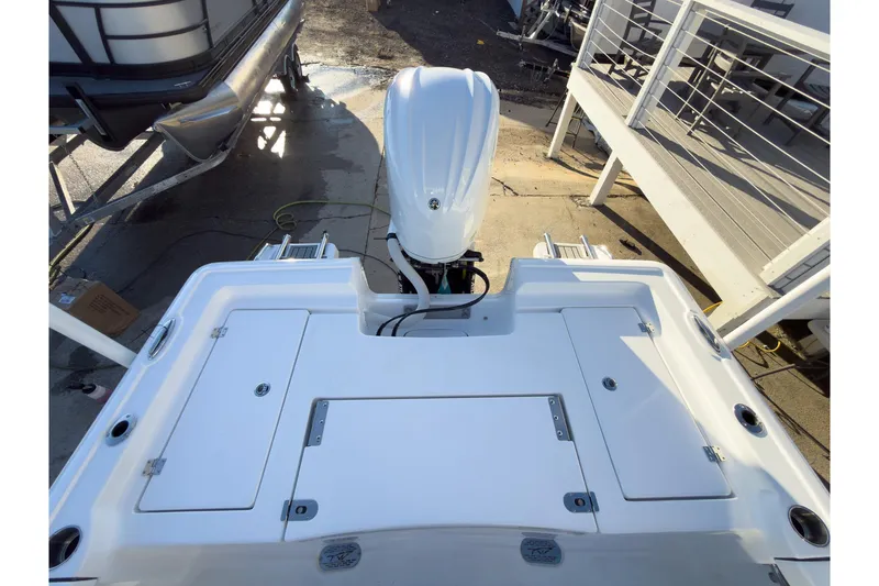 Slide: The Image of 2026 Tidewater 2300 Carolina Bay boat with outboard motor, docked at marina. - 22