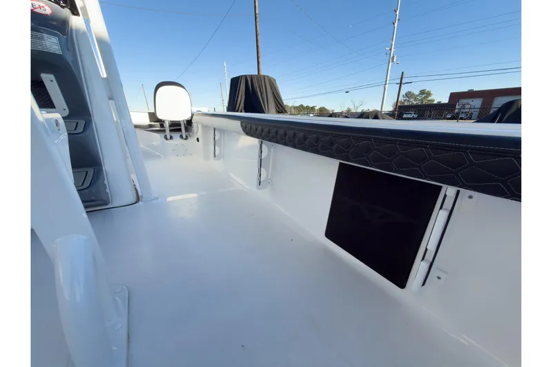 Slide: The Image of 2026 Tidewater 2300 Carolina Bay boat interior, featuring sleek white deck and cushioned seating. - 27