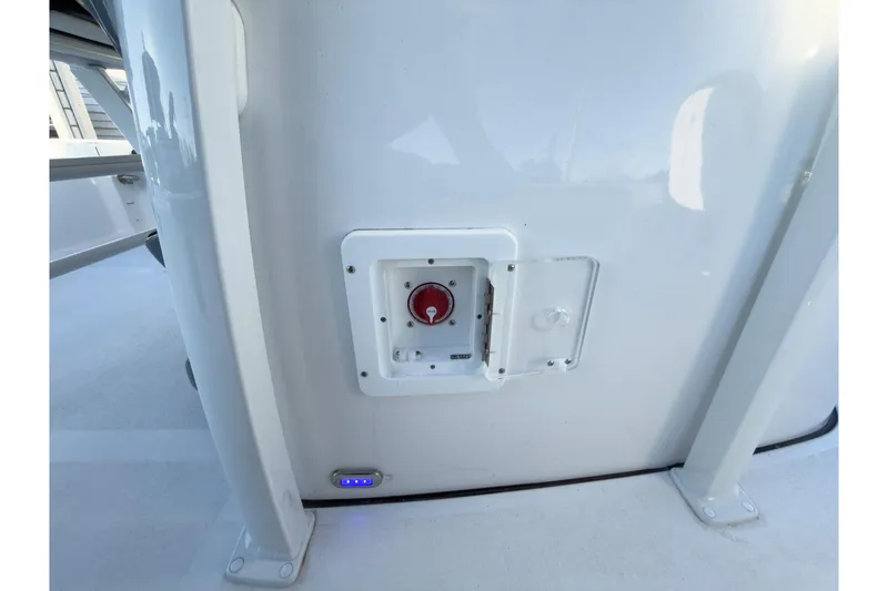 Slide: The Image of 2026 Tidewater 2300 Carolina Bay boat control panel with red switch and blue indicator light. - 28