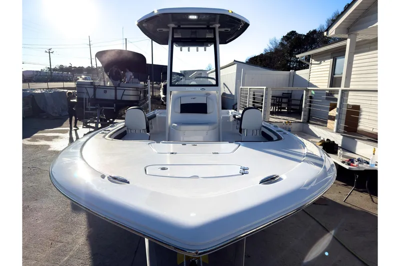 Slide: The Image of 2026 Tidewater 2300 Carolina Bay boat, sleek design, docked outdoors in sunlight. - 32