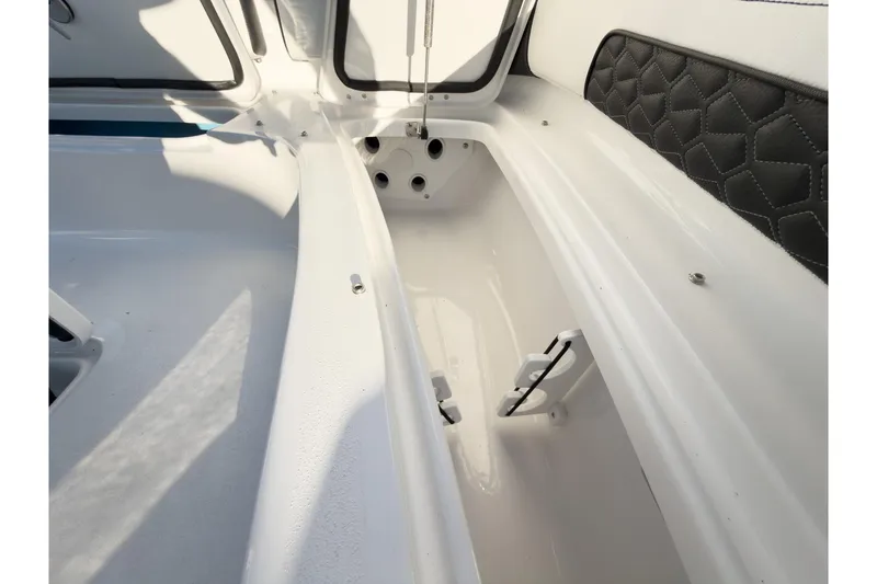 Slide: The Image of 2026 Tidewater 2300 Carolina Bay boat interior storage compartment with sleek design. - 39