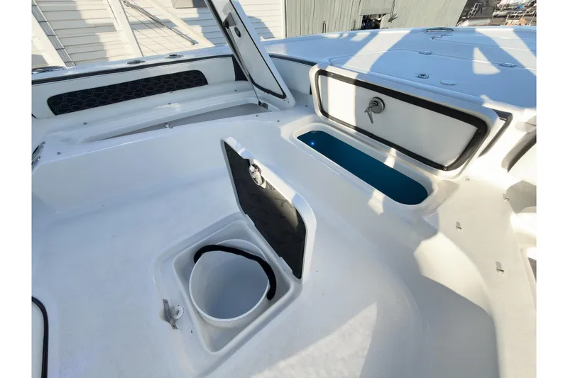 Slide: The Image of 2026 Tidewater 2300 Carolina Bay boat interior with storage compartments and clean white finish. - 40