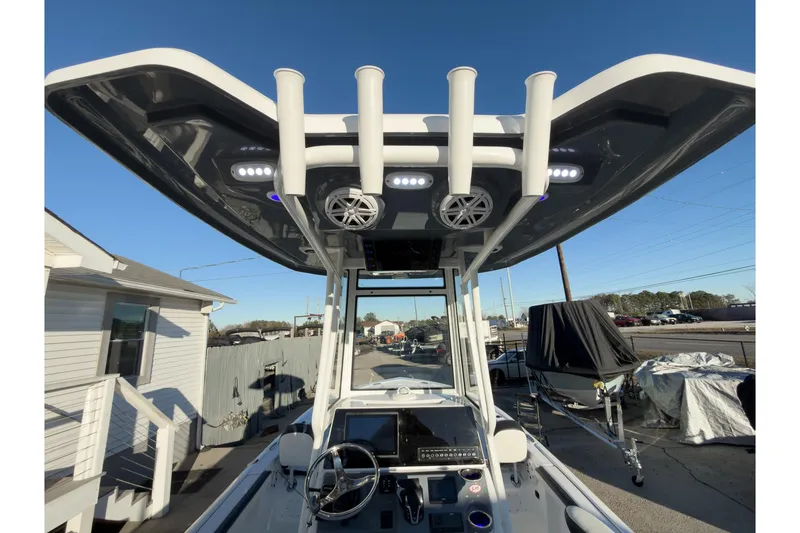 Slide: The Image of 2026 Tidewater 2300 Carolina Bay boat with T-top and console, docked outdoors. - 8