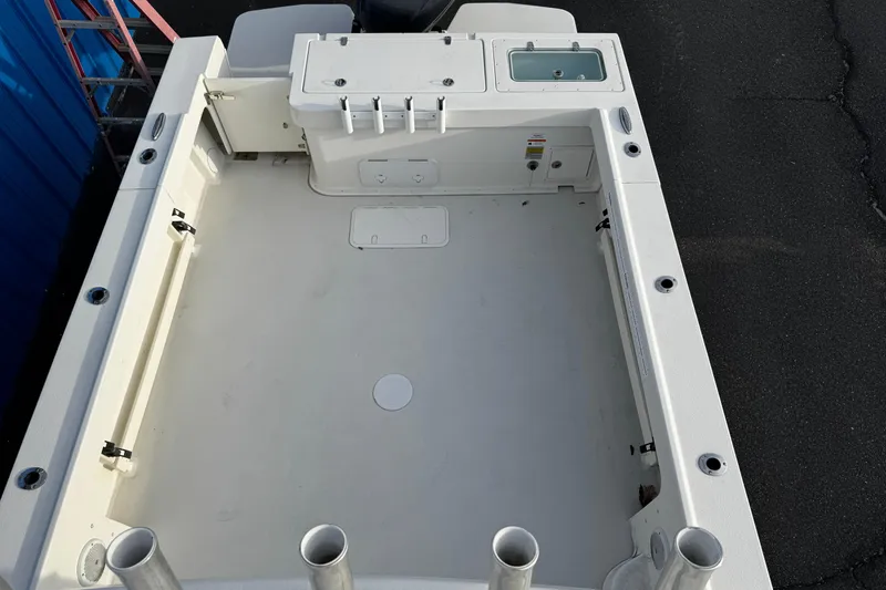 Slide: The Image of 2018 Parker 2520 XLD Sport Cabin boat deck with rod holders and storage compartments. - 13