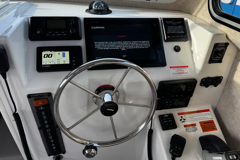 Slide: The Image of 2018 Parker 2520 XLD Sport Cabin dashboard with Garmin navigation and Yamaha controls. - 17