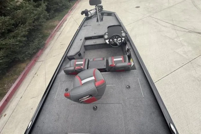 Slide: The Image of 2021 Ranger RT178 boat interior with gray and red seating, steering console, and spacious deck. - 12