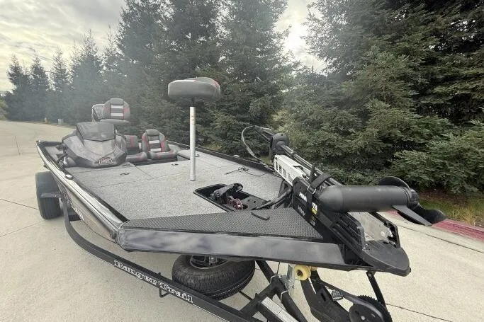 Slide: The Image of 2021 Ranger RT178 fishing boat on trailer, surrounded by trees. - 3