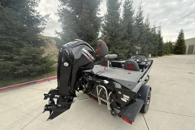 Slide: The Image of 2021 Ranger RT178 boat with Mercury engine, parked outdoors near trees. - 6