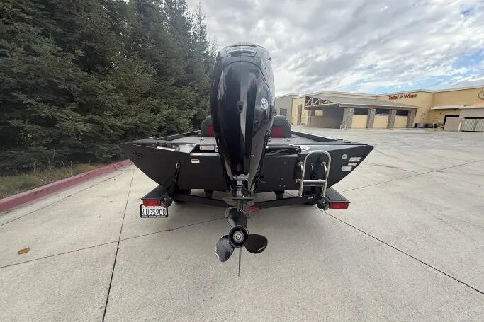 Slide: The Image of 2021 Ranger RT178 boat on trailer, rear view, outdoors near trees and buildings. - 7