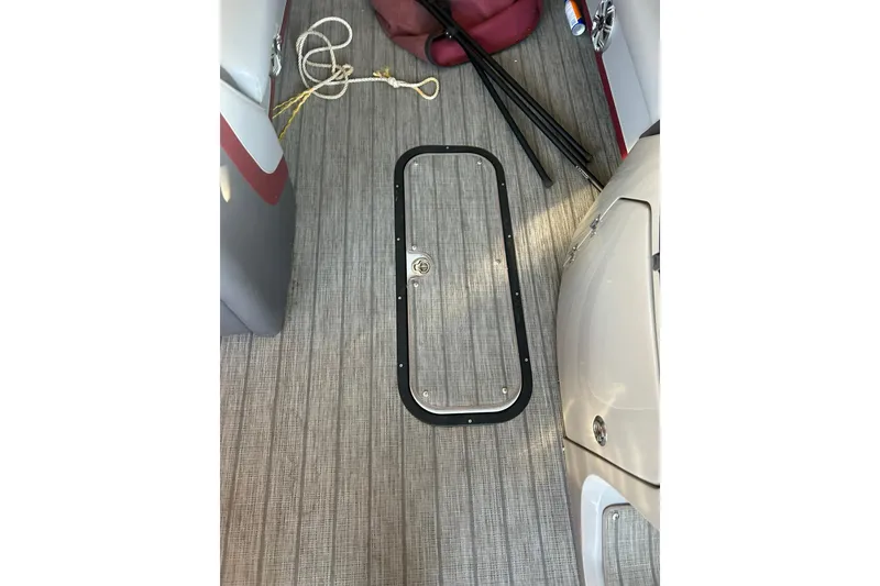 Slide: The Image of 2020 Manitou 25 Oasis SR SHP pontoon boat with Evinrude engine, parked outdoors. - 10