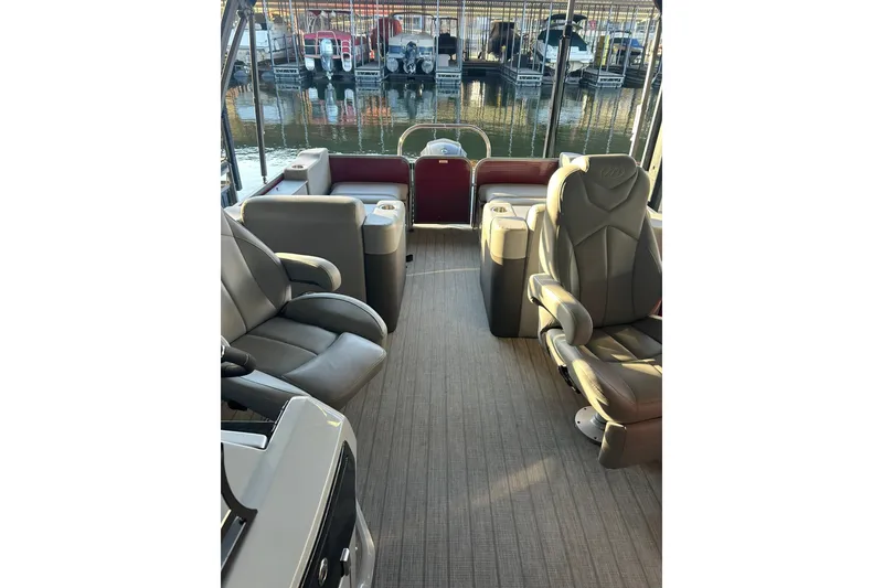 Slide: The Image of 2020 Manitou 25 Oasis SR SHP pontoon boat on trailer in parking lot. - 11