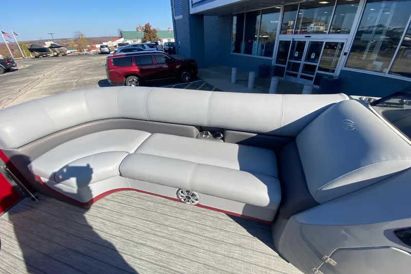 Slide: The Image of 2020 Manitou 25 Oasis SR SHP boat with gray seating and outdoor dealership view. - 17