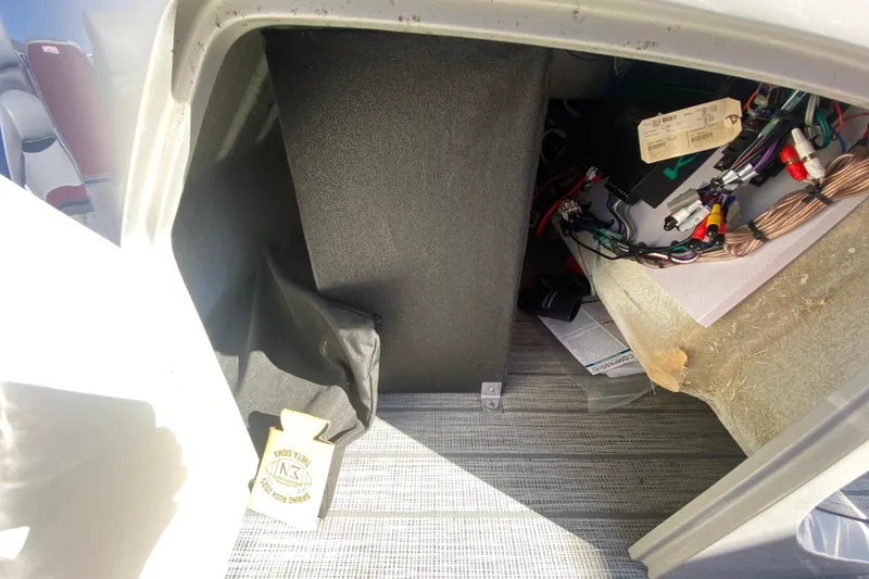 Slide: The Image of Interior view of a 2020 Manitou 25 Oasis SR SHP boat storage compartment with wiring. - 19