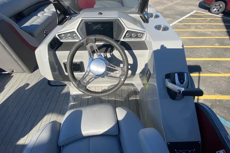 Slide: The Image of 2020 Manitou 25 Oasis SR SHP boat dashboard with steering wheel and controls. - 22