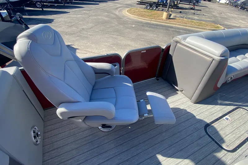 Slide: The Image of 2020 Manitou 25 Oasis SR SHP boat interior with plush seating and footrest. - 31