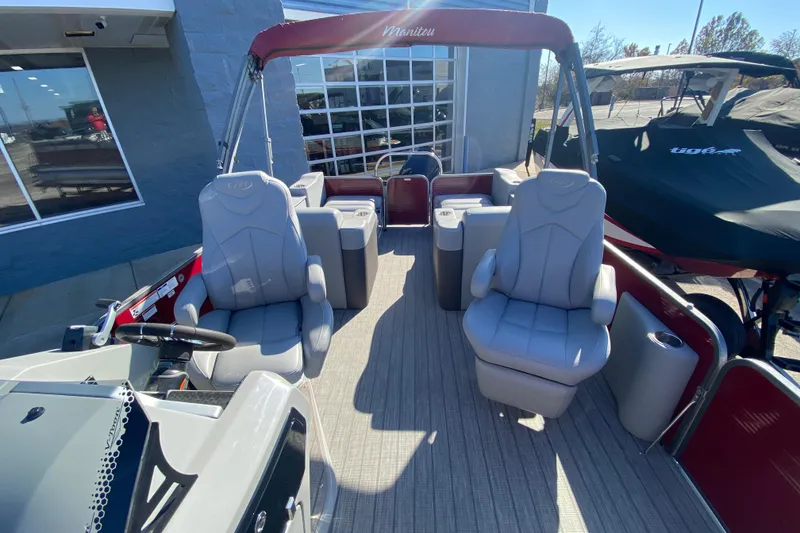 Slide: The Image of 2020 Manitou 25 Oasis SR SHP pontoon boat interior with plush seating and modern design. - 33