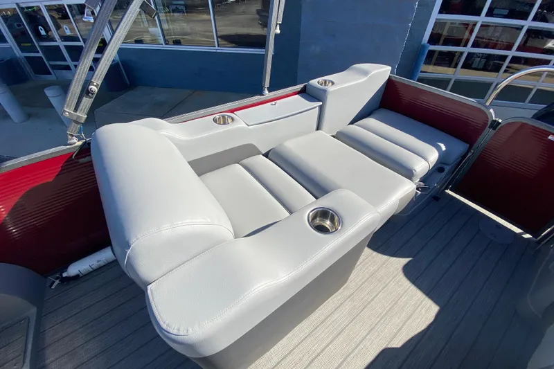 Slide: The Image of 2020 Manitou 25 Oasis SR SHP boat interior with gray seating and cup holders. - 34