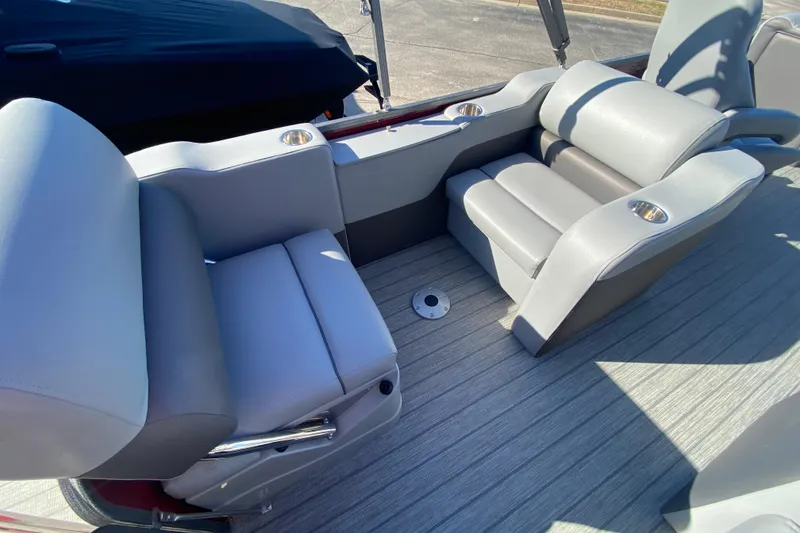 Slide: The Image of 2020 Manitou 25 Oasis SR SHP boat interior with gray seating and cup holders. - 37