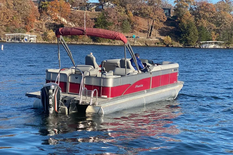 Slide: The Image of 2020 Manitou 25 Oasis SR SHP pontoon boat on a scenic lake. - 4