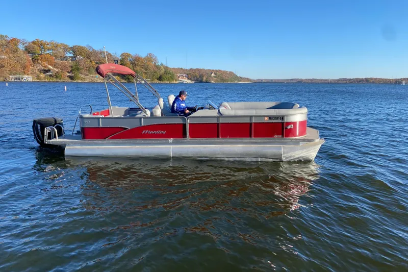 Slide: The Image of 2020 Manitou 25 Oasis SR SHP pontoon boat docked in a marina. - 6