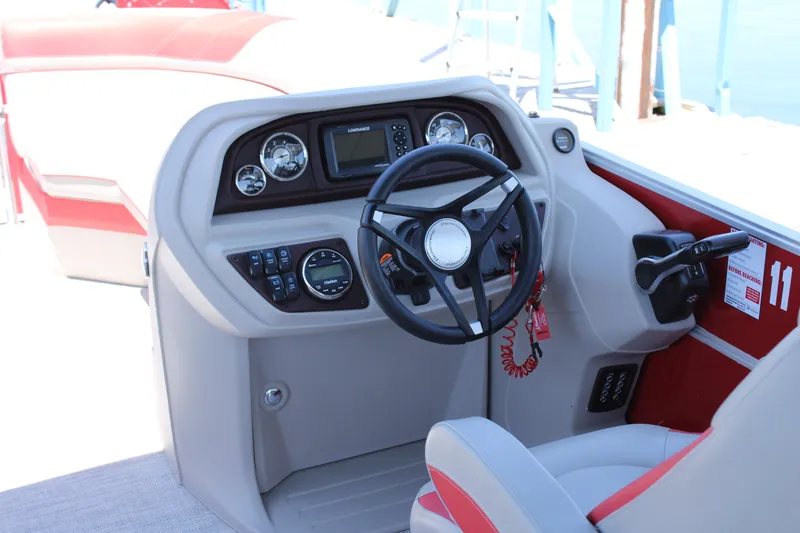 Slide: The Image of 2024 Berkshire 24RFX LE boat dashboard with steering wheel and control panel. - 4
