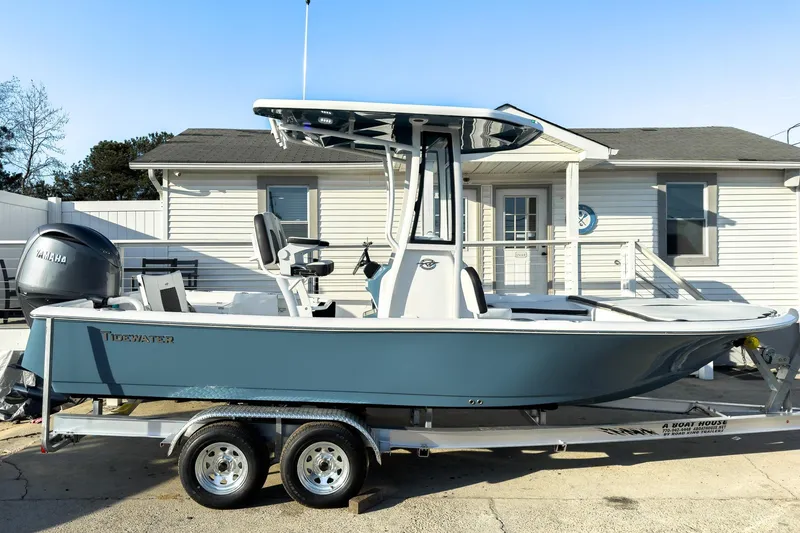 The Image of 2026 Tidewater 2210 Carolina Bay boat on trailer, parked outside a building. - 0