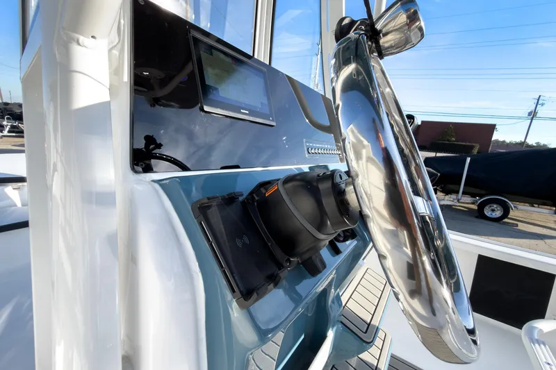 Slide: The Image of 2026 Tidewater 2210 Carolina Bay boat dashboard with steering wheel and electronic display. - 16