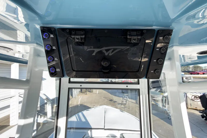 Slide: The Image of 2026 Tidewater 2210 Carolina Bay boat console with control panel and switches. - 17