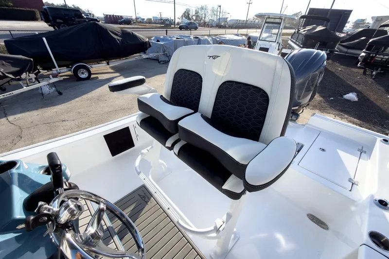 Slide: The Image of 2026 Tidewater 2210 Carolina Bay boat interior with dual seats and steering wheel. - 20