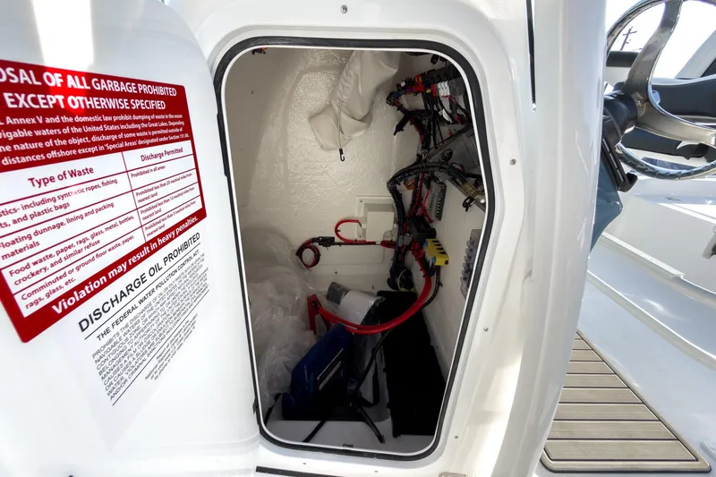 Slide: The Image of Electrical compartment of 2026 Tidewater 2210 Carolina Bay boat with wiring and safety instructions. - 28