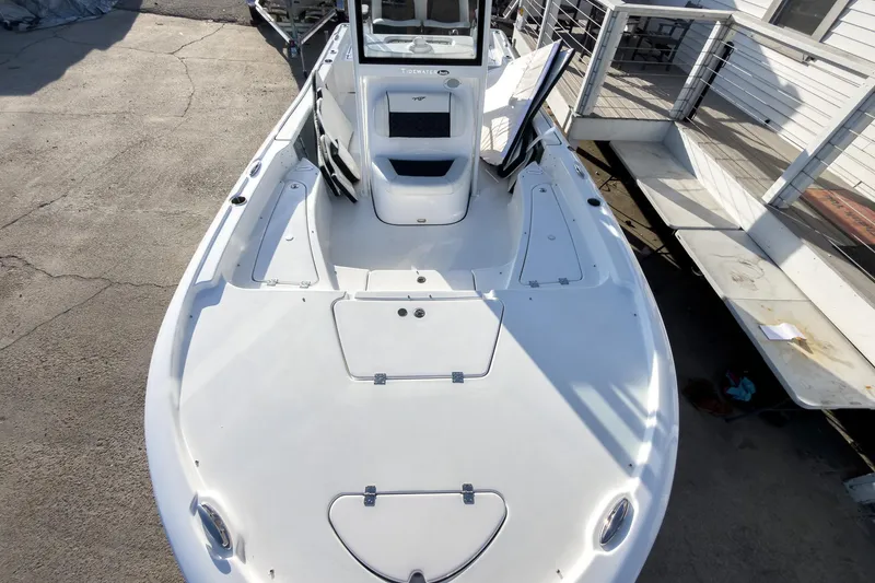 Slide: The Image of 2026 Tidewater 2210 Carolina Bay boat, top view, docked on concrete surface. - 36