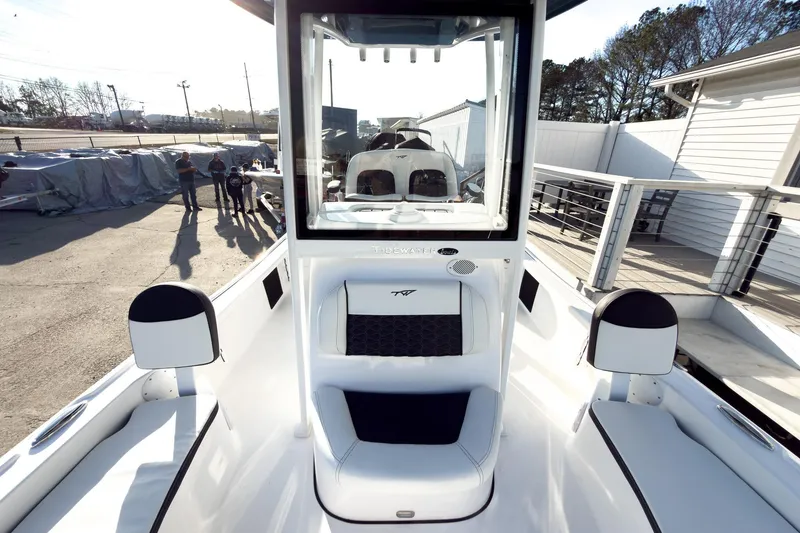 Slide: The Image of 2026 Tidewater 2210 Carolina Bay boat interior with seating and console, docked outdoors. - 39