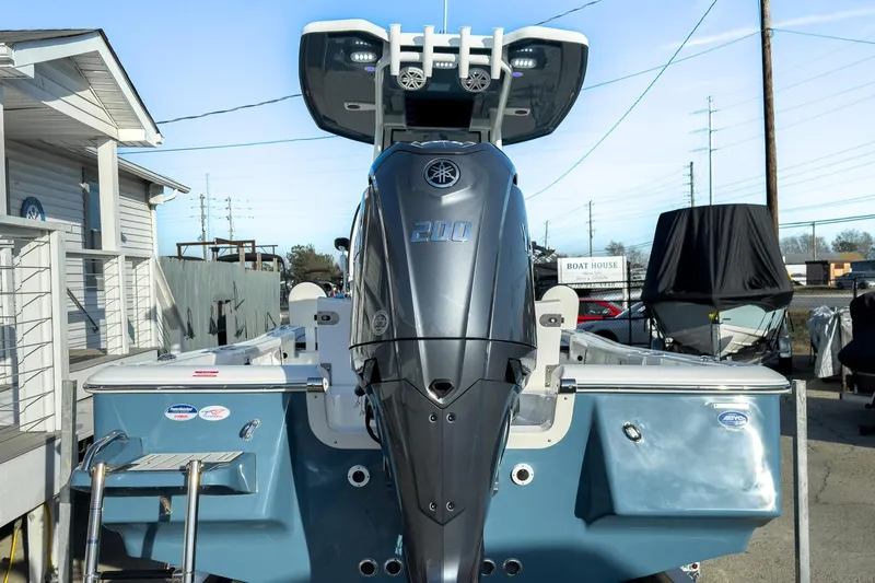 Slide: The Image of 2026 Tidewater 2210 Carolina Bay boat with powerful outboard motor, docked at marina. - 4