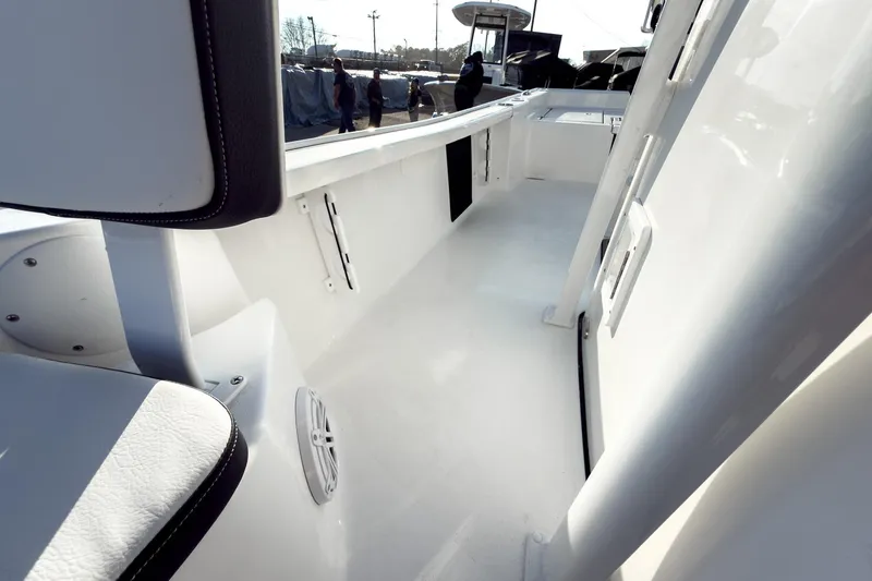 Slide: The Image of 2026 Tidewater 2210 Carolina Bay boat interior with sleek white design and seating. - 40