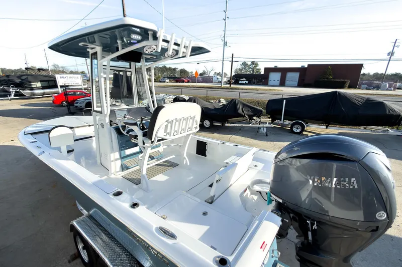 Slide: The Image of 2026 Tidewater 2210 Carolina Bay boat with Yamaha engine, parked outdoors. - 6