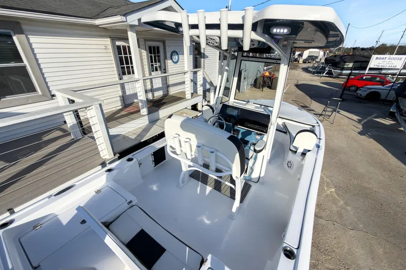 Slide: The Image of 2026 Tidewater 2210 Carolina Bay boat, sleek design, docked near a modern building. - 9