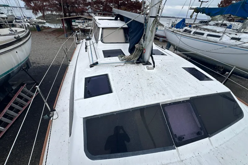 Slide: The Image of 2014 Gemini Legacy 35 sailboat on land, surrounded by other boats, overcast sky. - 22