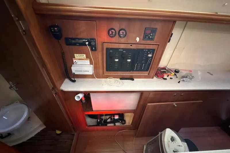 Slide: The Image of Interior of 2014 Gemini Legacy 35 boat with wooden cabinetry and nautical equipment. - 28